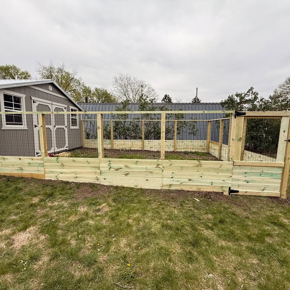 Repaired vinyl and wood fencing on a Nebraska property by KD Fencing