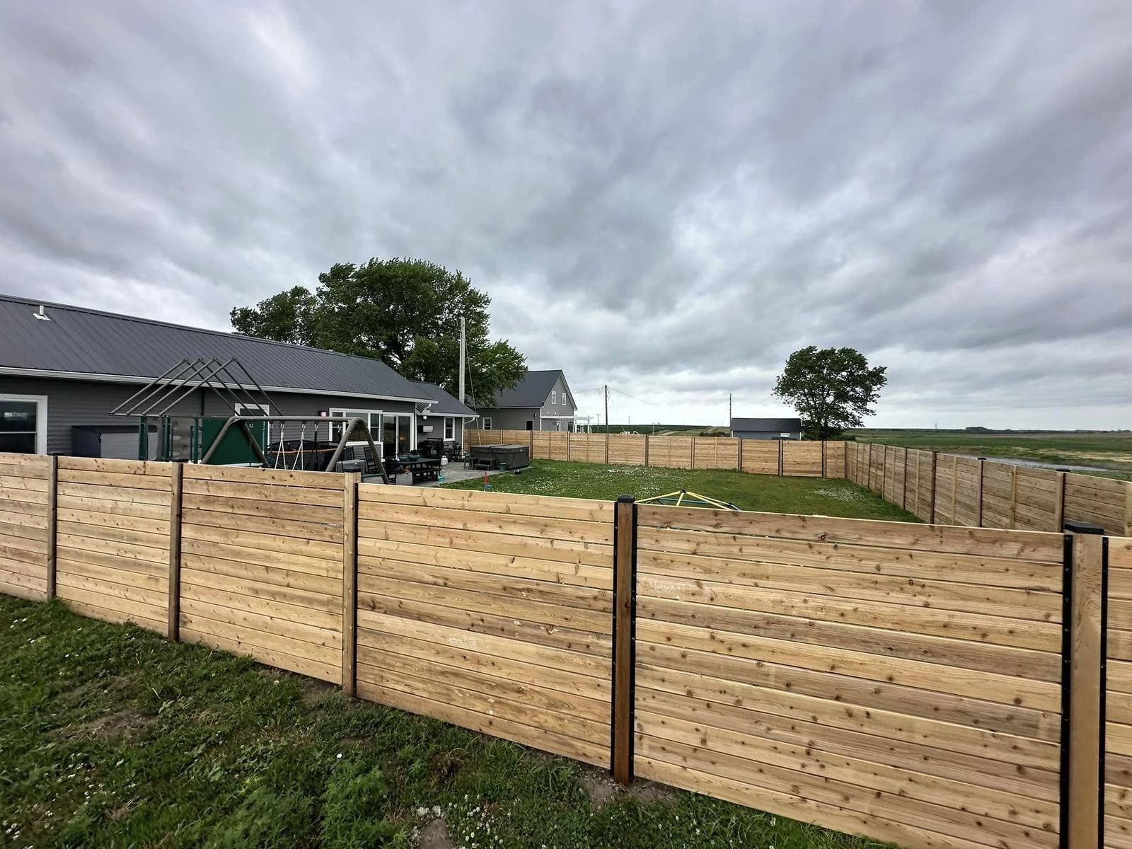 Long wood privacy fence run on a Nebraska acreage installed by KD Fencing